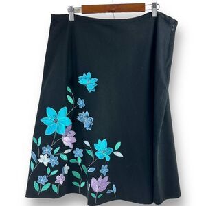 Anne Carson black with colorful embroidery and appliqué flowers and butterflies